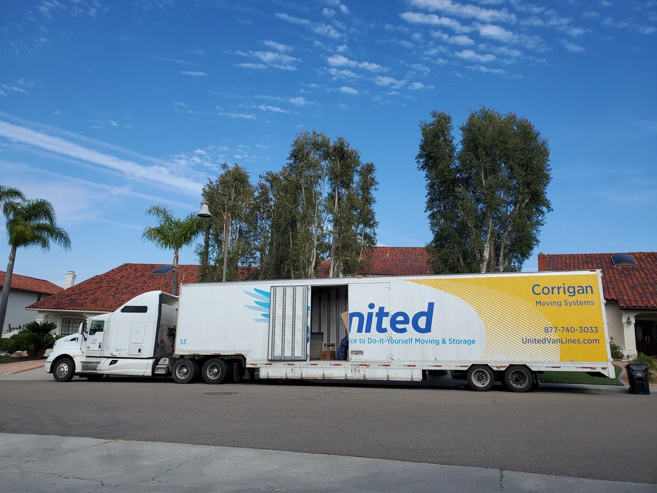 Moving truck parked on residential street.