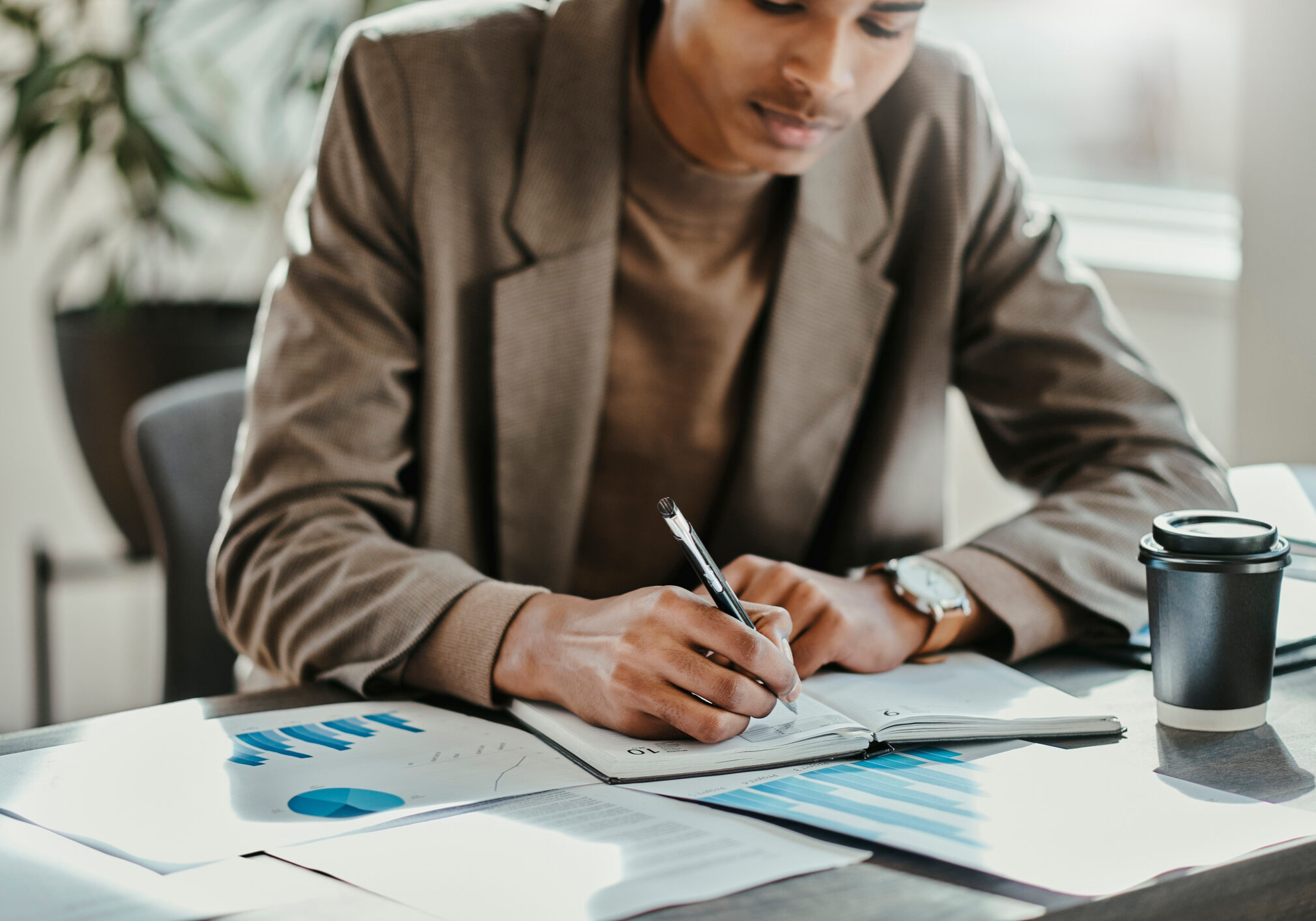 Black businessman, chart documents or notebook writing of office schedule, kpi data anaylsis or company finance budget. Worker, employee or marketing creative and paper infographic of growth timeline